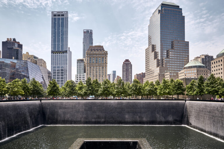 The 9/11 Memorial south pool with the buildings of Manhattan, New York in the background